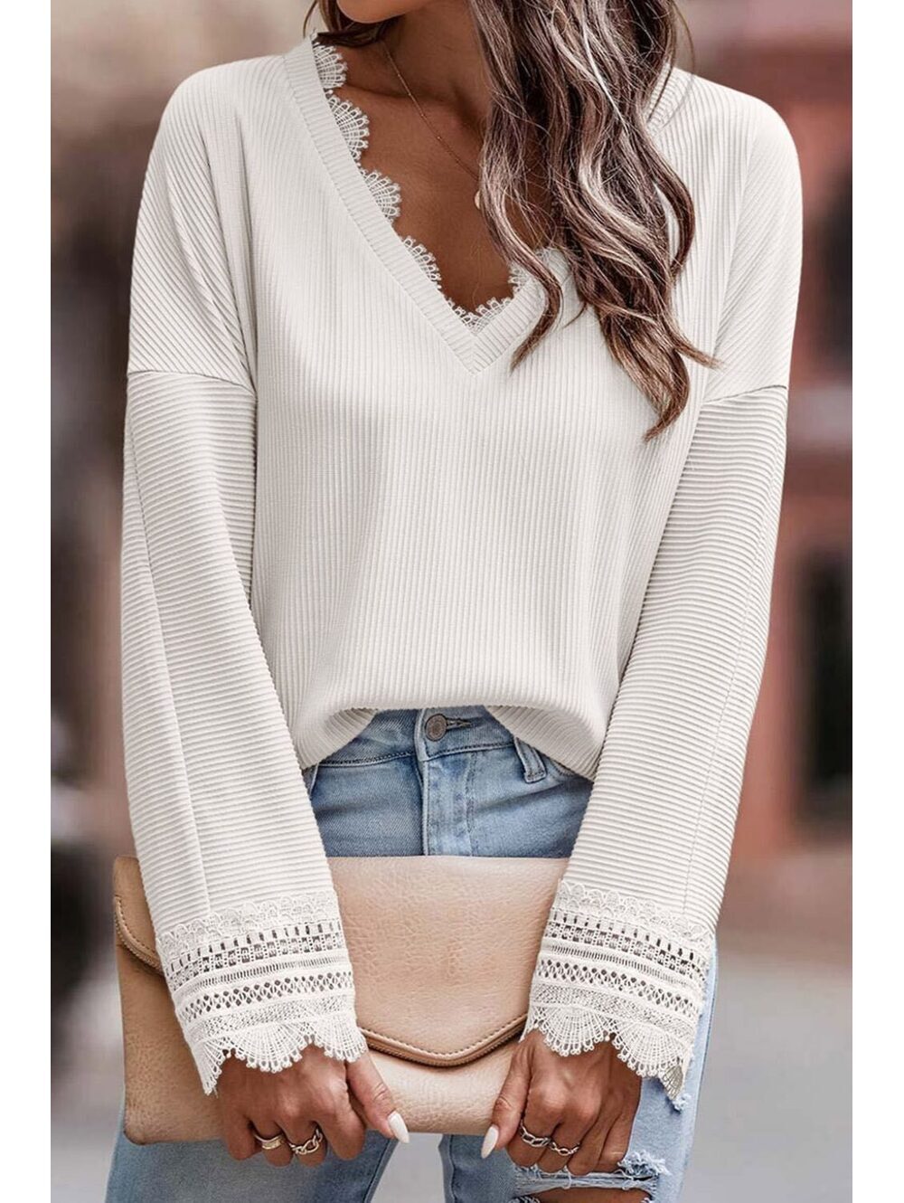 White ribbed long-sleeve with delicate lace trim along V-neckline and cuffs.